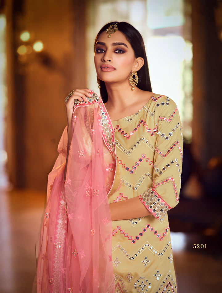 Pink and yellow Indian gharara outfit for weddings, with raw silk top