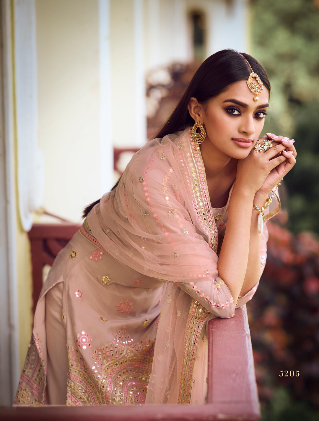 Elegant light peach Sharara suit with embroidered organza top, soft net plaited bottom, and embroidered dupatta.