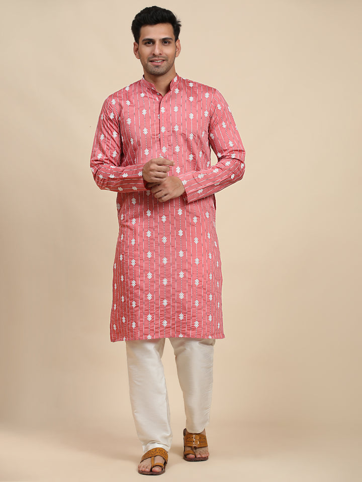 Pink viscose rayon kurta for men, lightweight and adorned with woven motifs, perfect for festive celebrations.