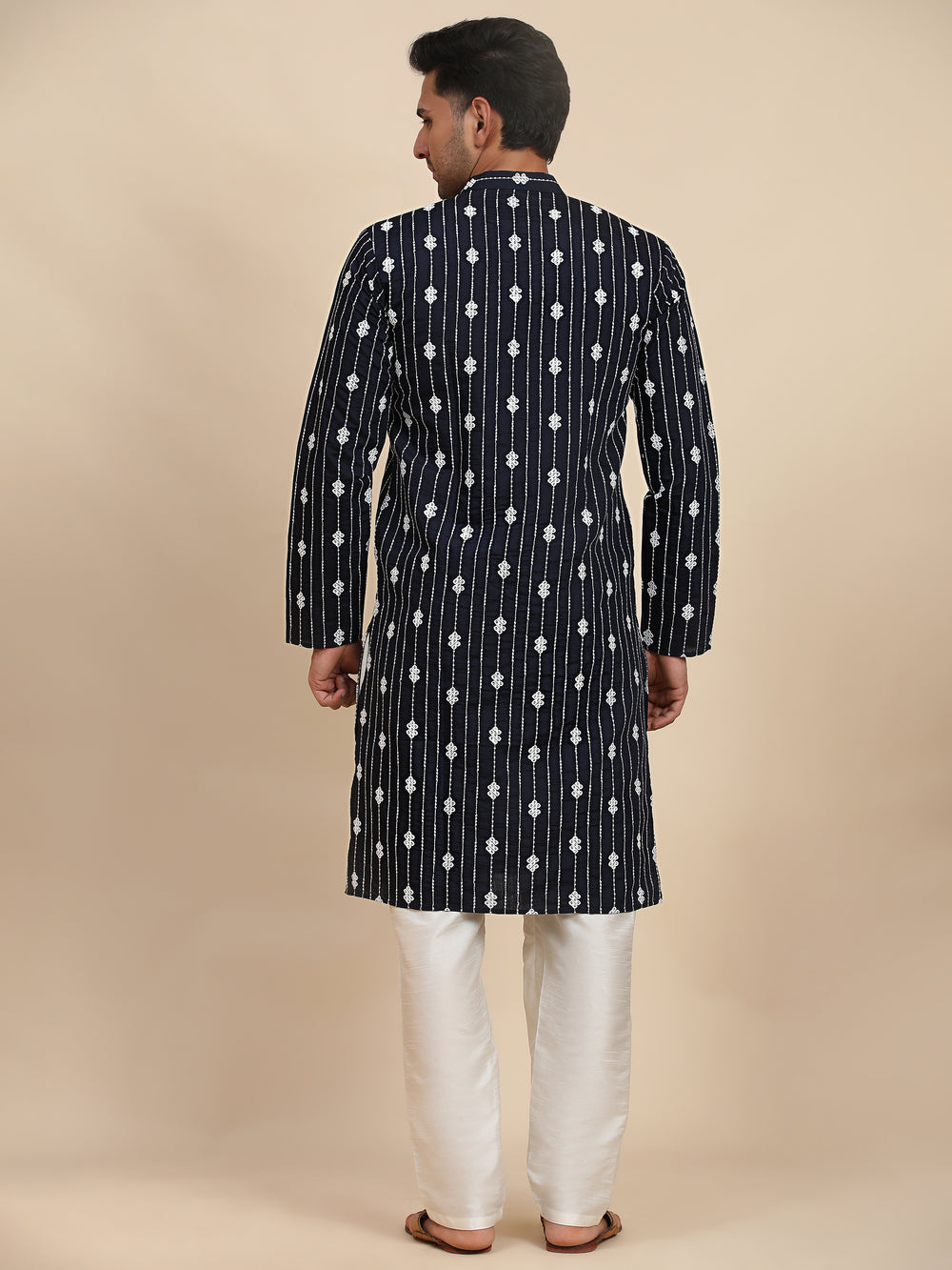 Elegant navy blue kurta featuring sophisticated weaved motifs, designed for casual gatherings and cultural events.