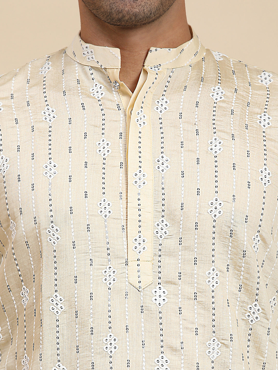 Ethnic cream kurta with intricate motifs, designed for festive occasions and casual elegance.