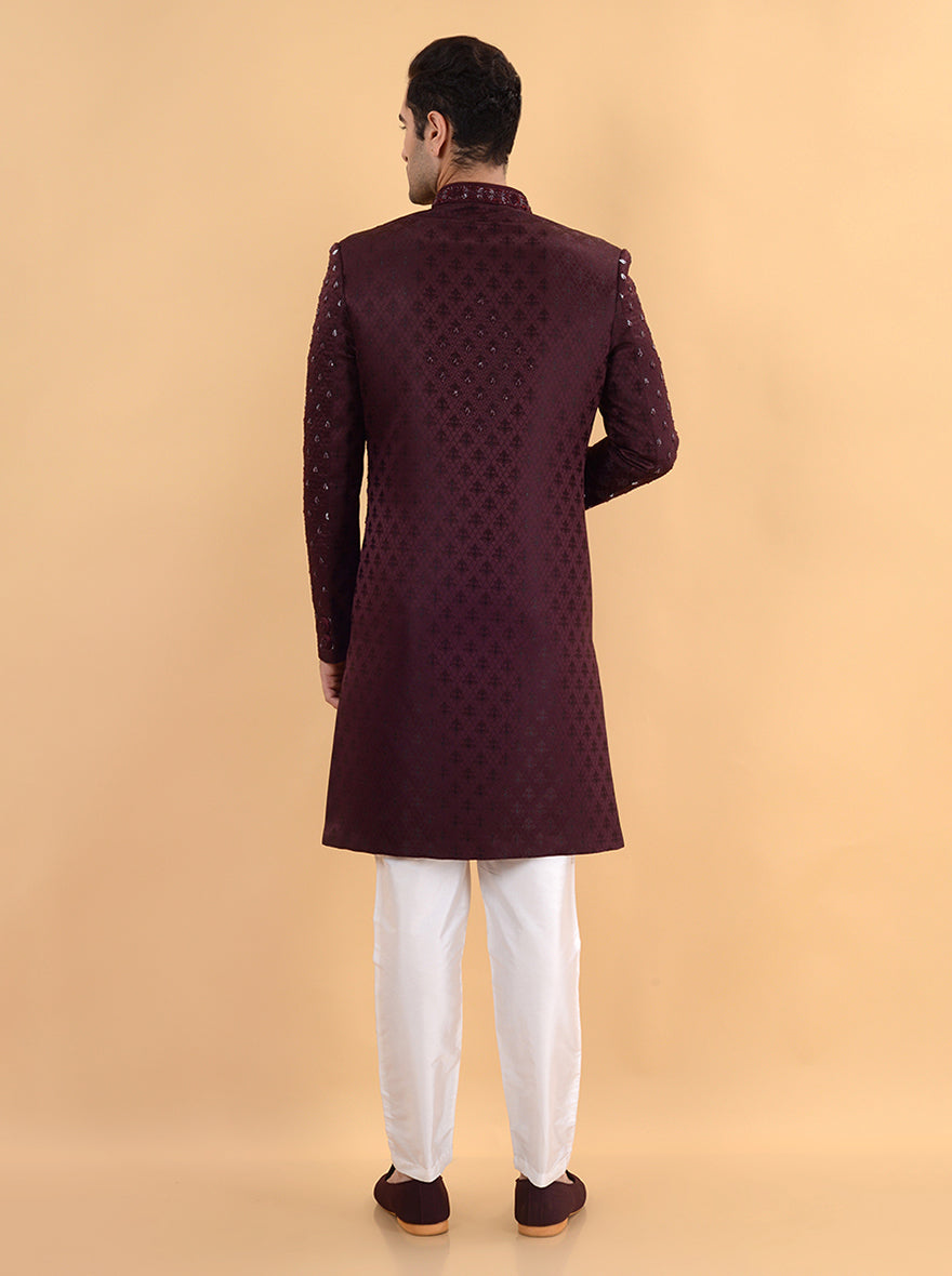 Make a fashionable statement at your next sangeet or engagement ceremony in the USA with this stylish wine jacquard sherwani, showcasing intricate details and a rich color.