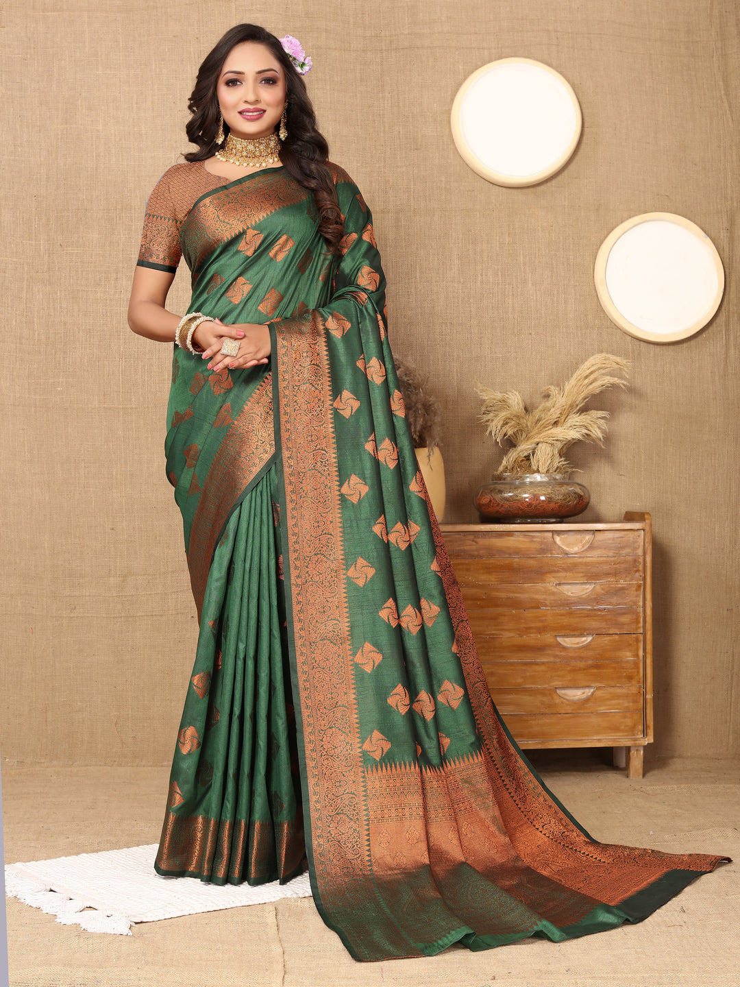 Elegant dark green katan silk saree with intricate copper zari design and a beautiful zari border, ideal for grand celebrations.