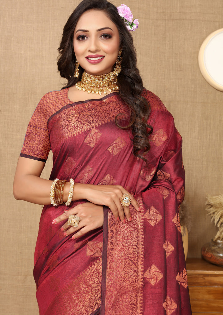 Sophisticated maroon katan silk saree with intricate copper zari design, a stunning choice for formal events and celebrations.