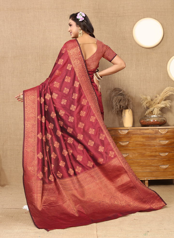 Opulent maroon katan silk saree with copper zari detailing and rich zari border, perfect for weddings and cultural gatherings.