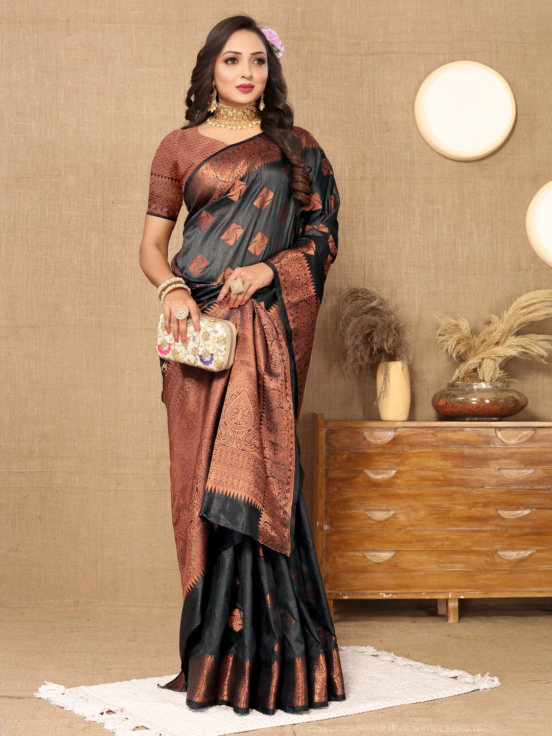 Elegant black katan silk saree featuring detailed copper zari work, zari pallu, and matching blouse piece, perfect for festive gatherings.