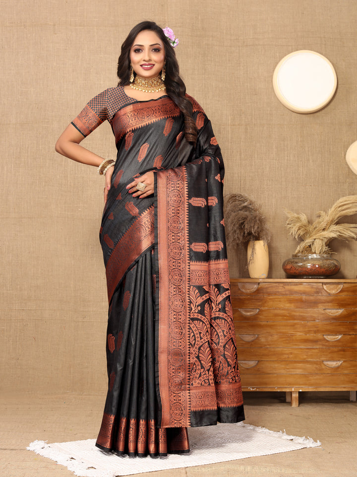 Elegant black Katan silk saree with intricate zari border, ideal for weddings and formal occasions.