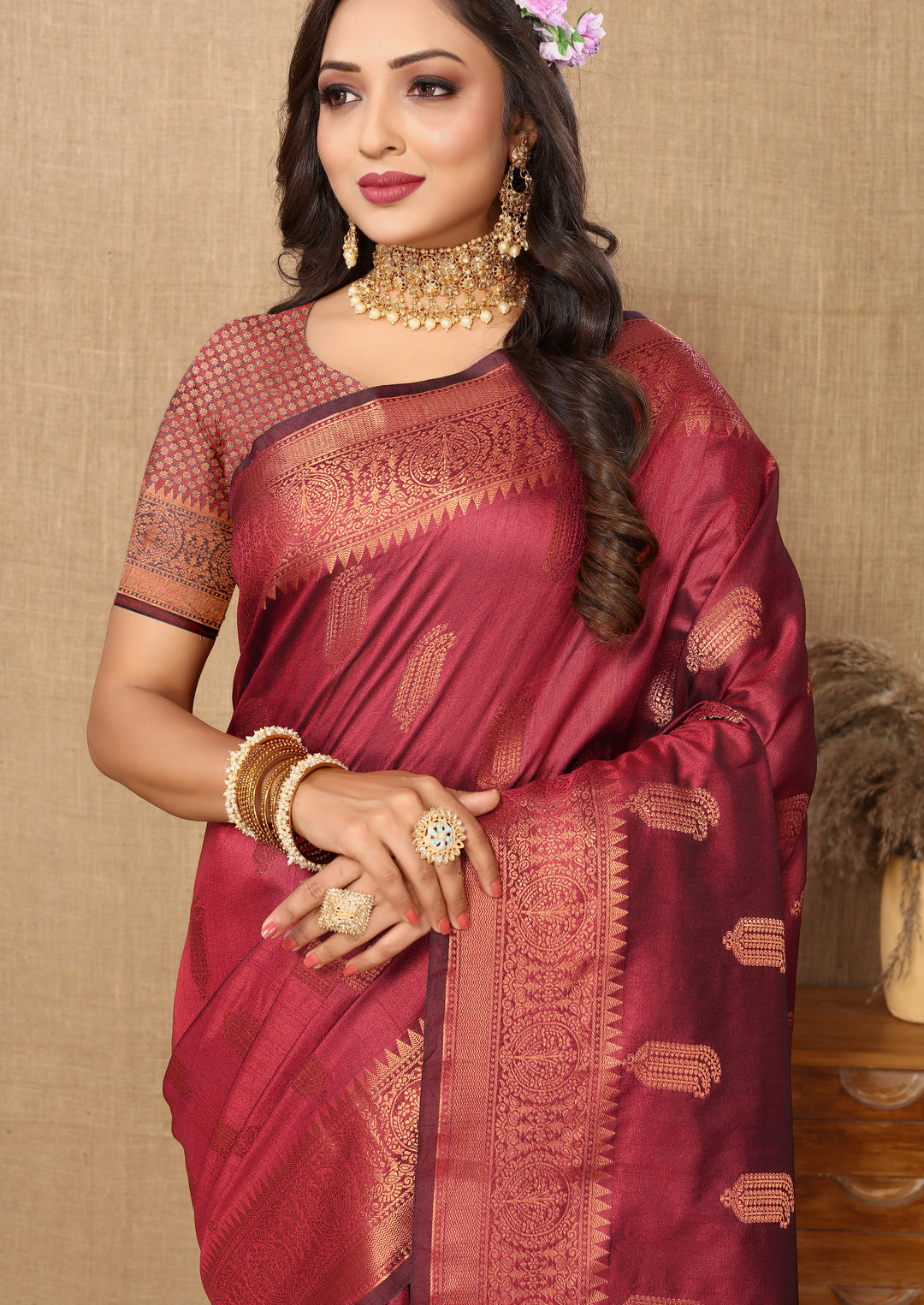 Maroon Katan silk saree with intricate zari border, ideal for grand celebrations.