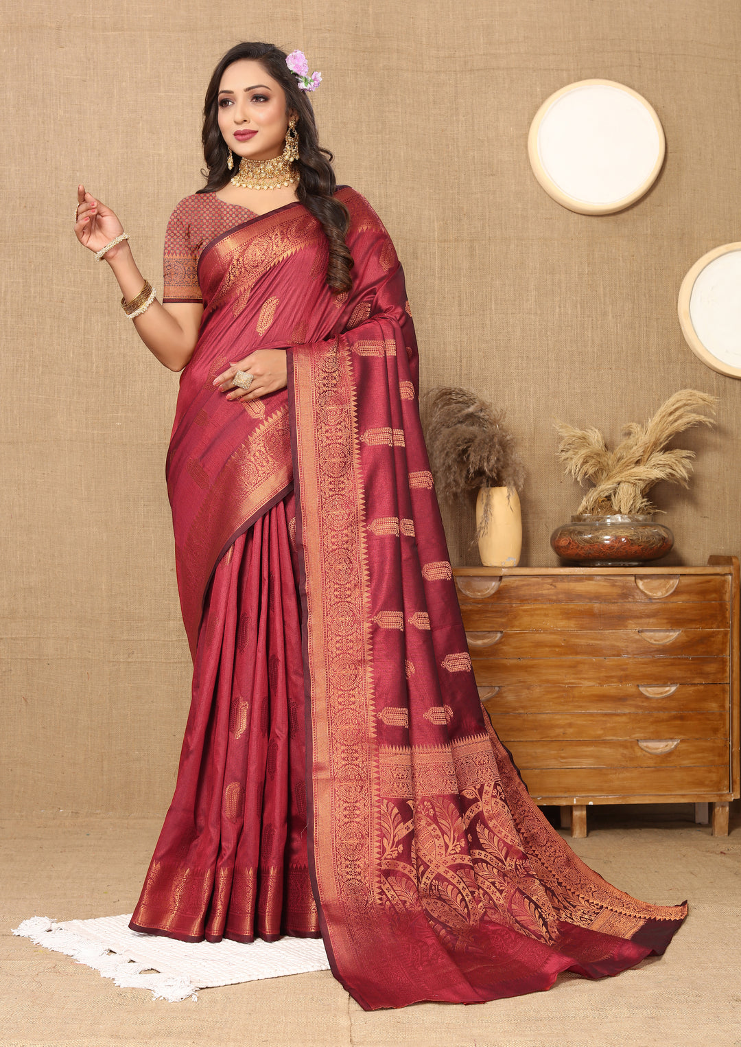 Designer maroon silk saree with luxurious zari border, perfect for cultural and formal occasions.