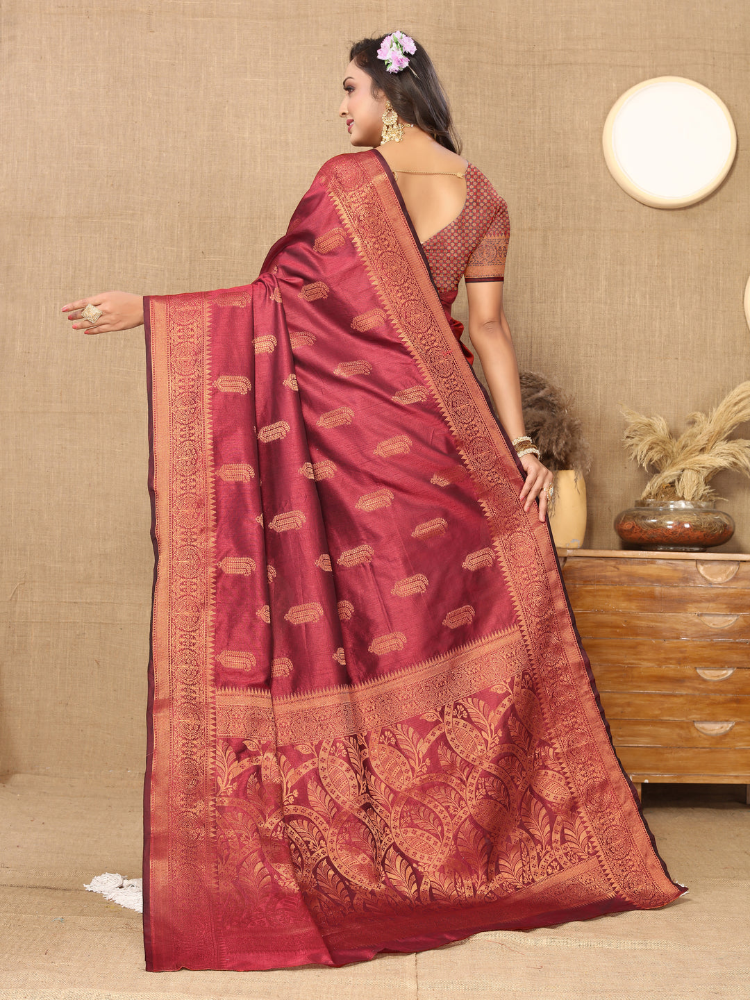 Elegant maroon silk saree featuring intricate zari work, perfect for weddings and special events.