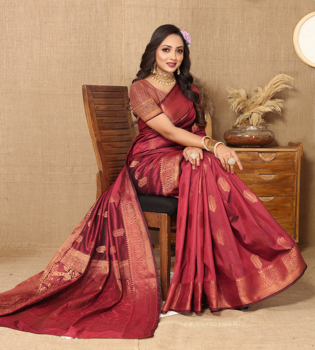 Luxurious maroon Katan silk saree with intricate zari designs, perfect for bridal celebrations.