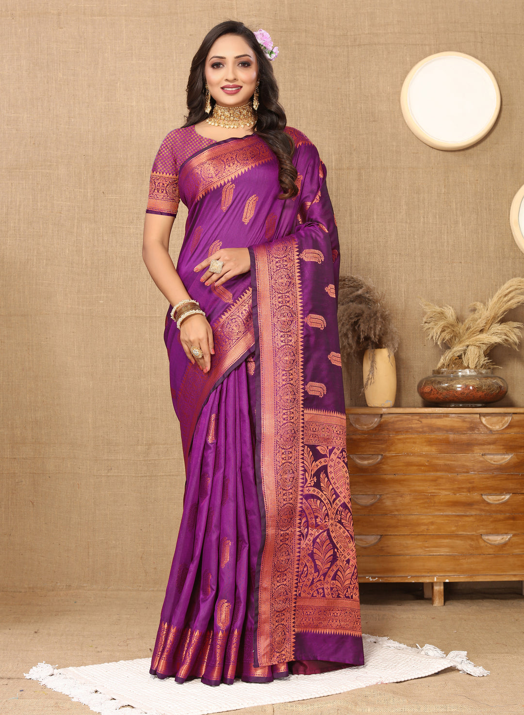 Designer purple silk saree with intricate zari border, ideal for grand celebrations.