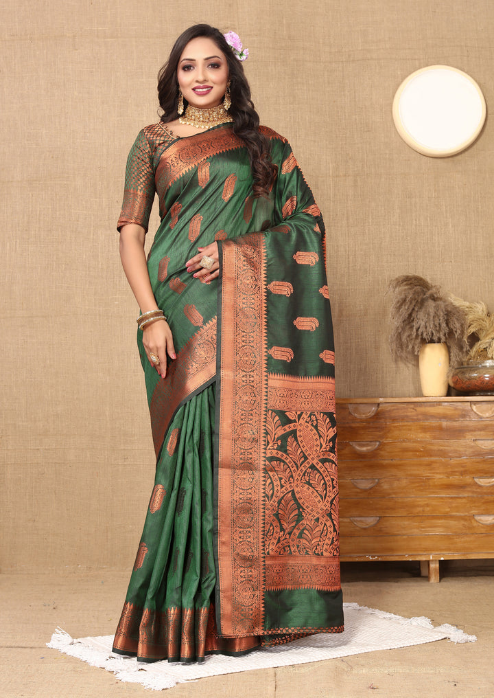 Elegant dark-green silk saree featuring intricate zari work, perfect for bridal and festive occasions.