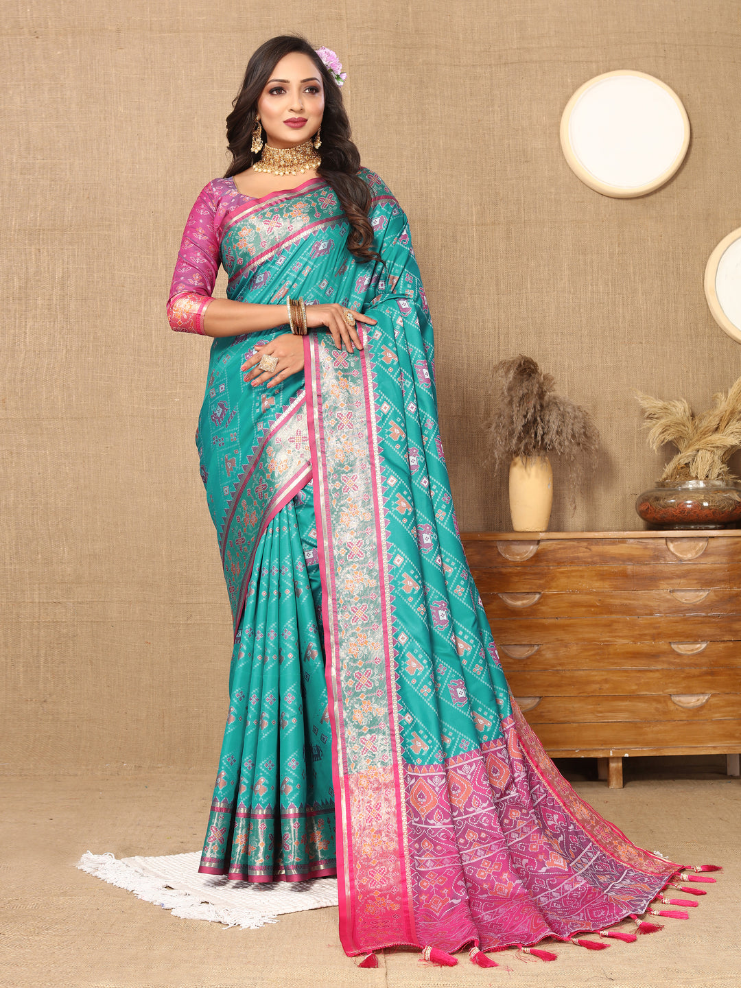 Elegant turquoise Patola silk saree with Meenakari motifs and zari accents, ideal for traditional Indian occasions.