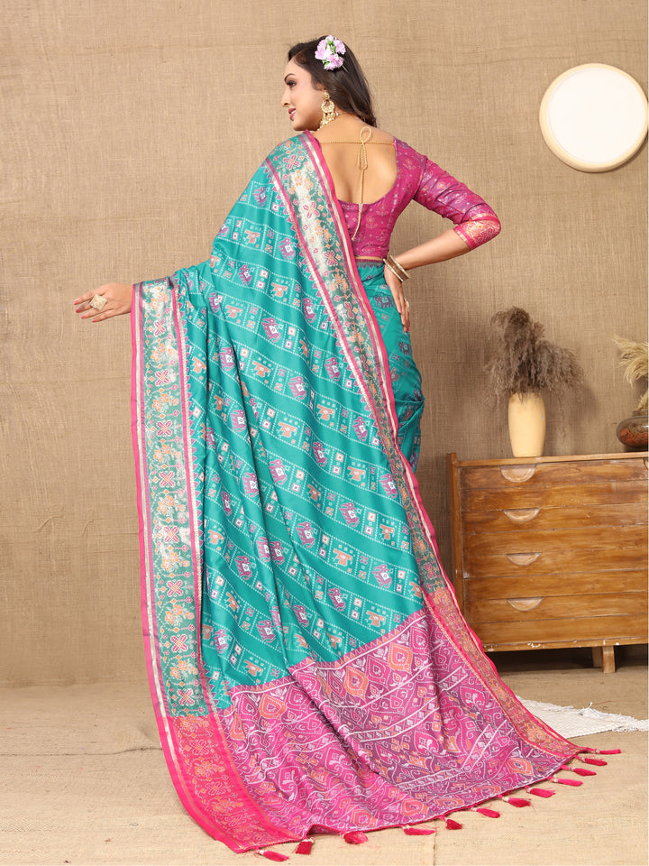 Stunning turquoise saree in Patola silk with intricate weaving and tassels, ideal for cultural celebrations.