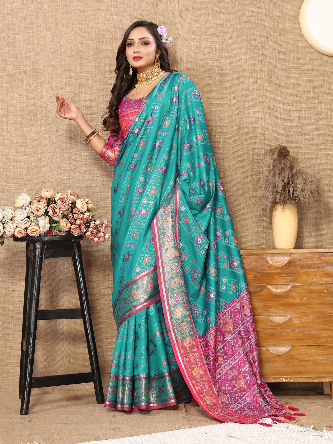 Gorgeous turquoise Patola silk saree with traditional Meenakari motifs and zari embellishments.