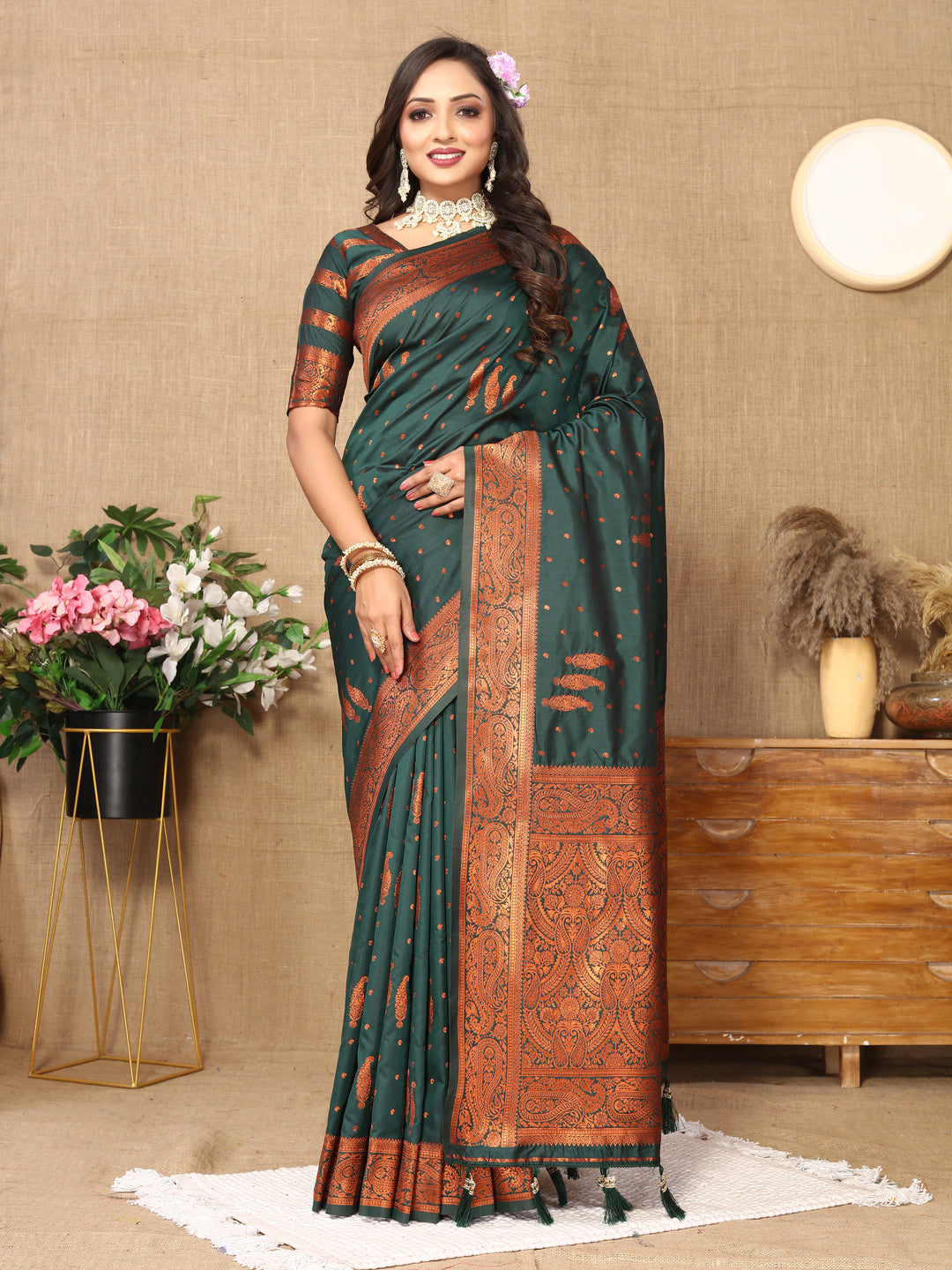 Elegant dark-green paisley woven Indian saree with rich zari pallu and contrast border for festive occasions.