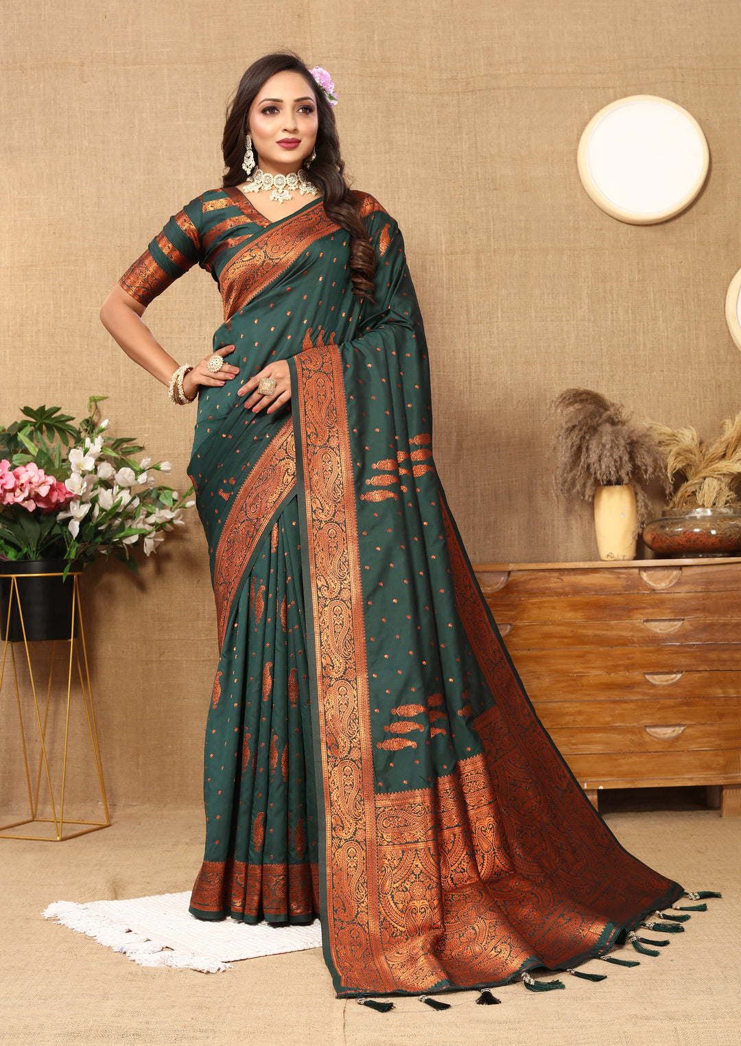 Timeless dark-green Indian saree with intricate paisley design, zari pallu, and contrast border, perfect for weddings.