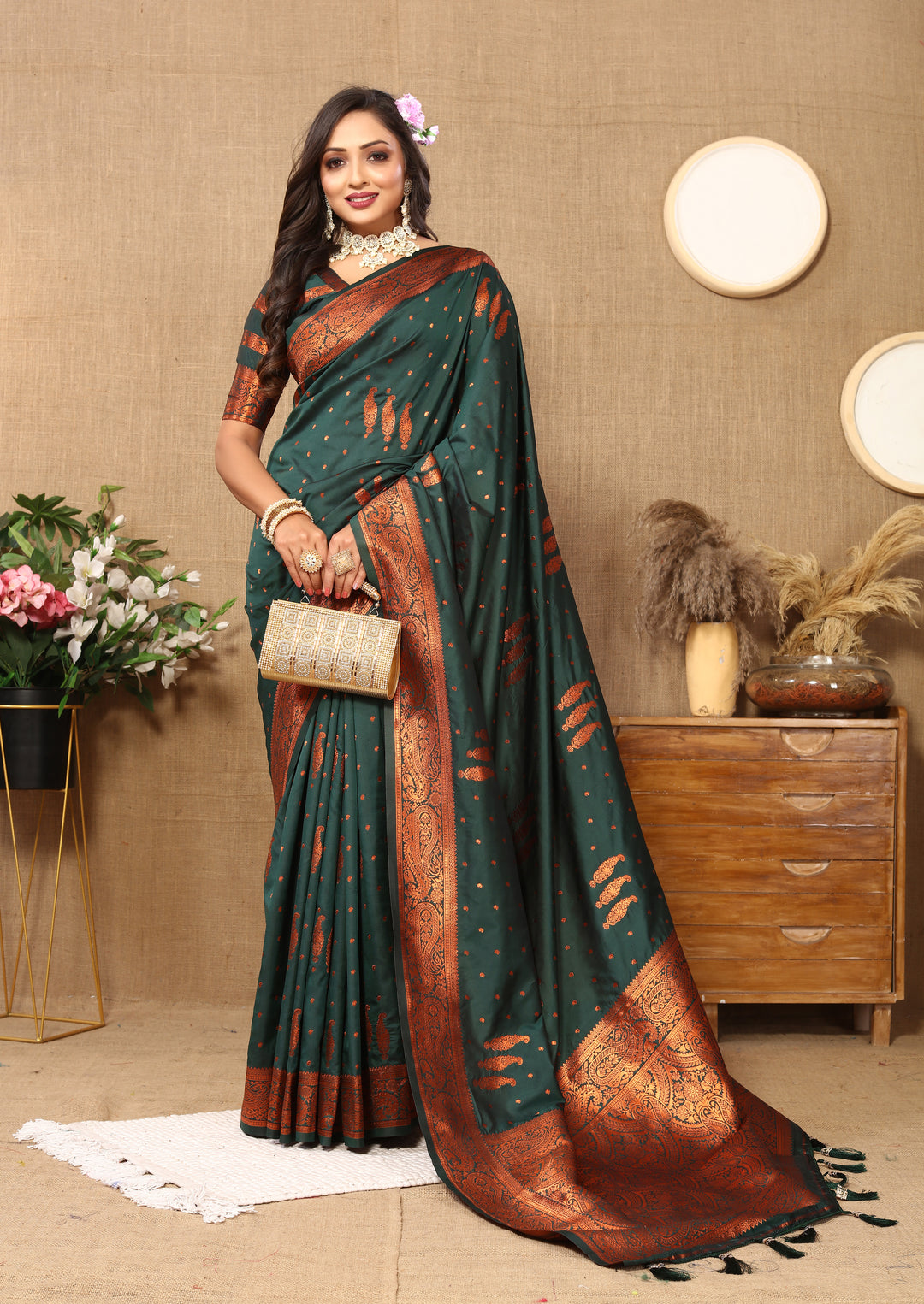 Classic dark-green paisley woven saree with intricate zari work and contrast border, perfect for traditional ceremonies.