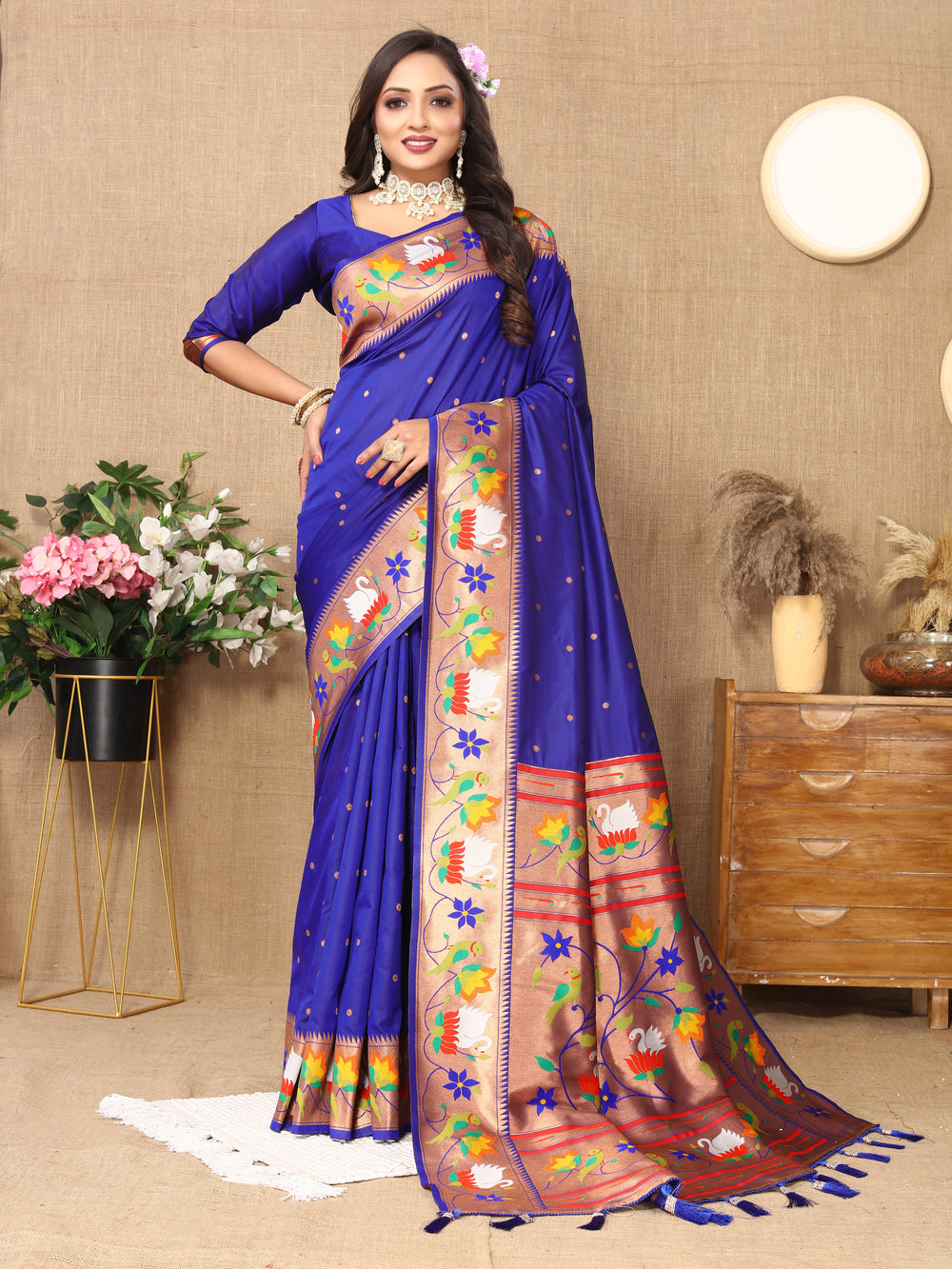 Elegant royal-blue Paithani silk saree with exquisite meenakari work and a zari border, ideal for traditional celebrations.