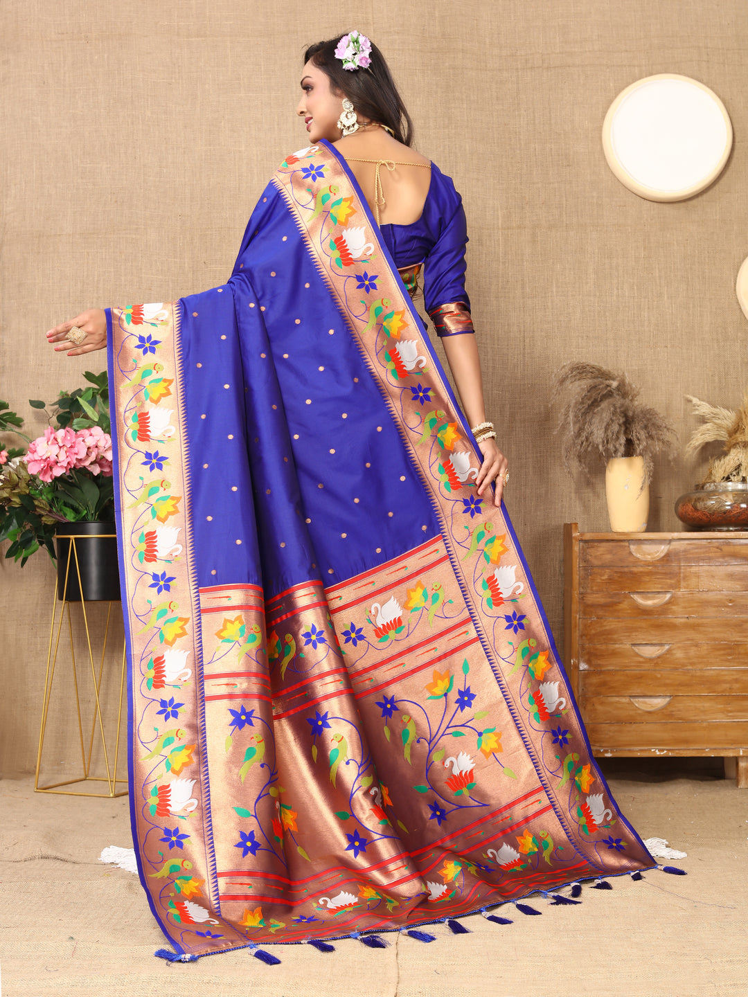 Elegant royal-blue Paithani silk saree with detailed meenakari weaving and zari border, ideal for formal gatherings.