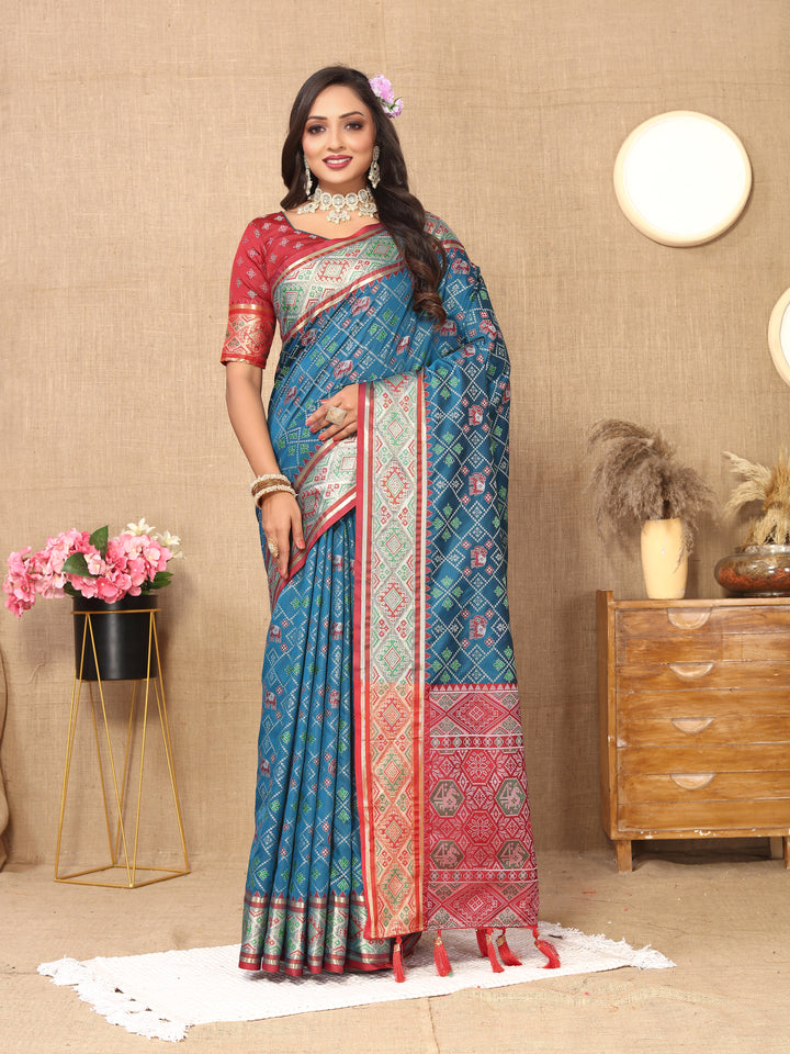 Teal blue Patola silk sari featuring intricate pallu design and shimmering zari work, perfect for weddings.