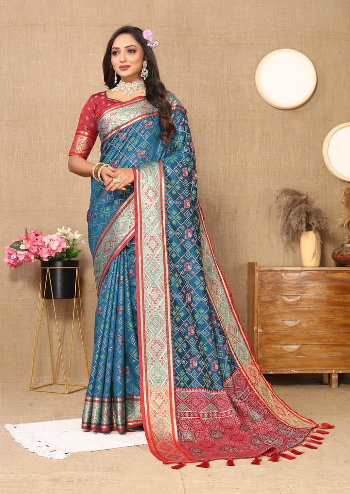 Designer teal blue Patola silk sari with luxurious zari work and intricate pallu, perfect for special gatherings.