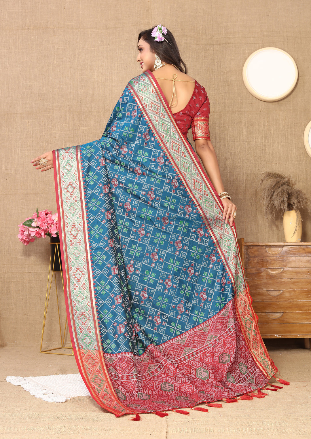 Classic teal blue Patola silk sari with detailed pallu and shimmering zari, ideal for traditional Indian ceremonies.