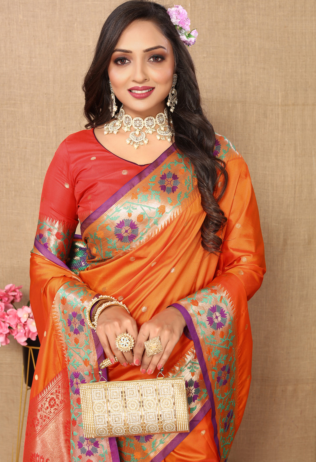 Beautiful orange Paithani silk saree, perfect for weddings, with intricate Meenakari and zari details.