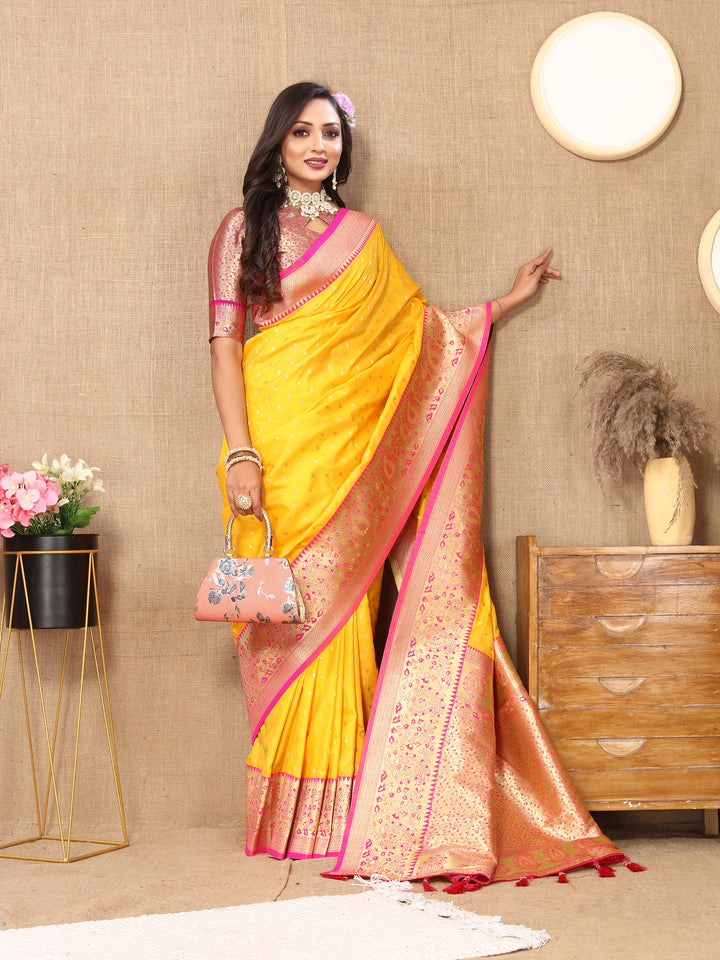 Radiant Yellow Soft Silk Saree with exquisite zari weaving and a rich brocade blouse for festive events.