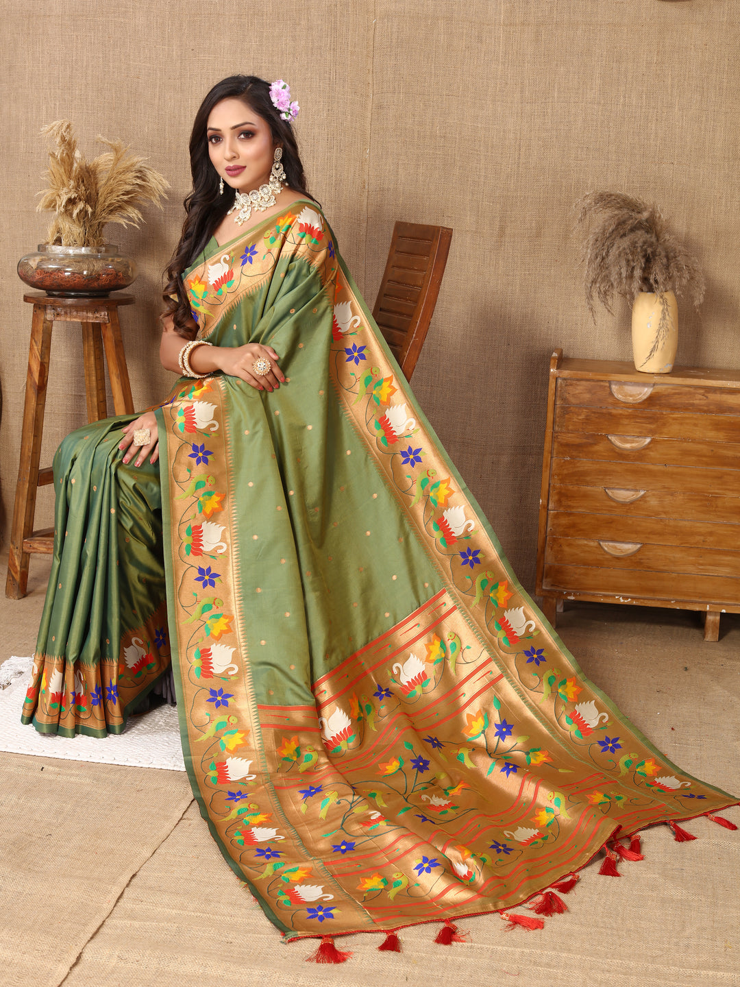 Elegant olive Paithani silk saree with rich meenakari weaving and a gold zari border, perfect for traditional gatherings.