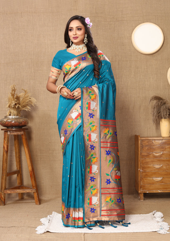 Elegant sky-blue Paithani silk saree with intricate meenakari weaving and a golden zari border, ideal for weddings.