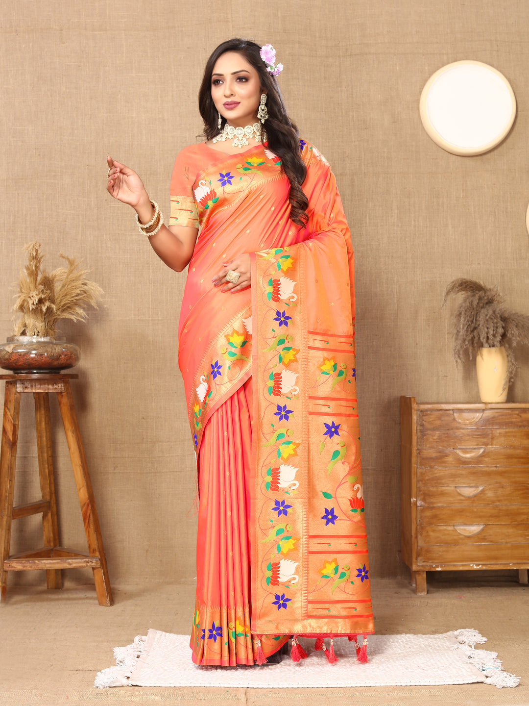 Beautiful orange Paithani silk saree with rich meenakari weaving and a luxurious zari border, perfect for cultural events.