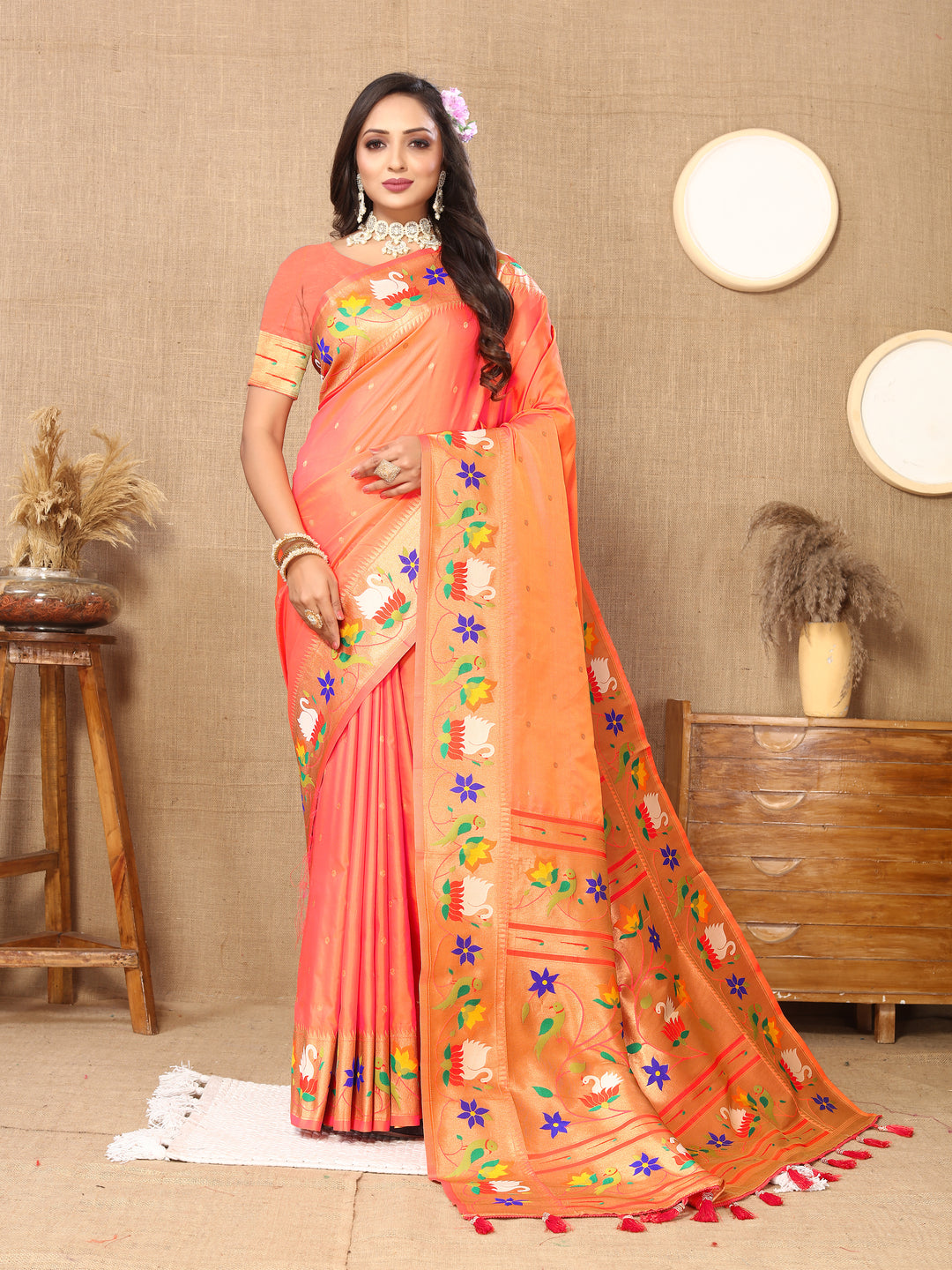 Elegant orange Paithani silk saree with intricate meenakari weaving and golden zari border, perfect for special occasions.