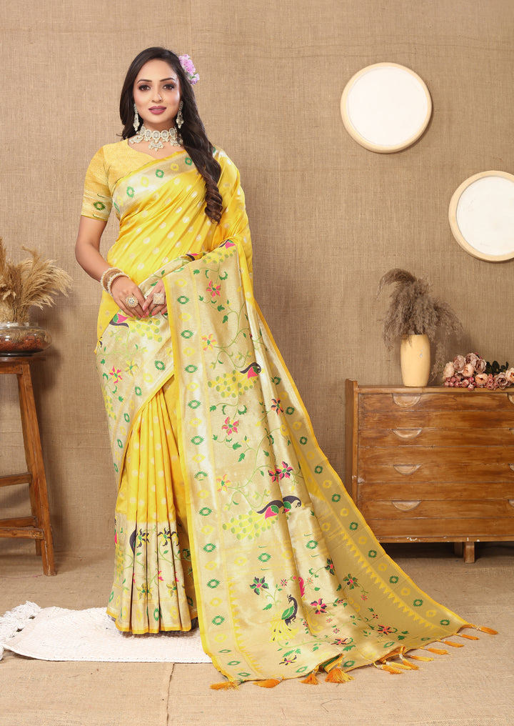 Elegant yellow silk saree featuring intricate zari details and matching silk blouse, perfect for celebrations.