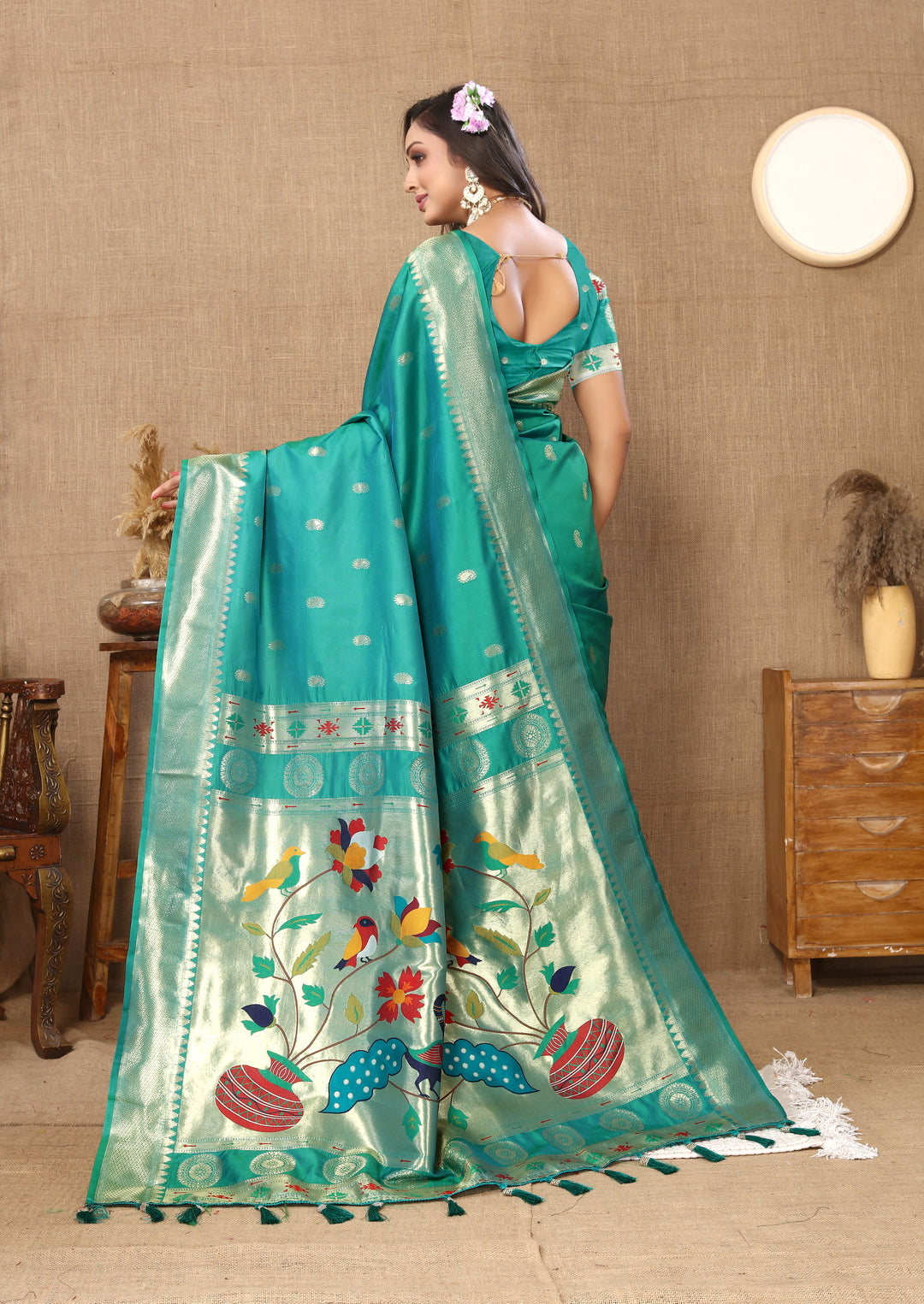 Traditional teal blue Paithani saree with matching blouse and detailed zari work, ideal for festive occasions.