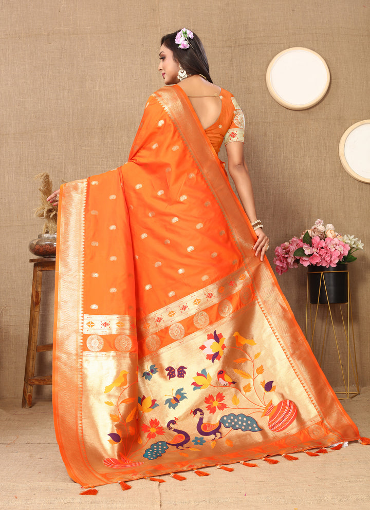 Traditional orange Paithani saree with intricate zari work, perfect for grand celebrations.