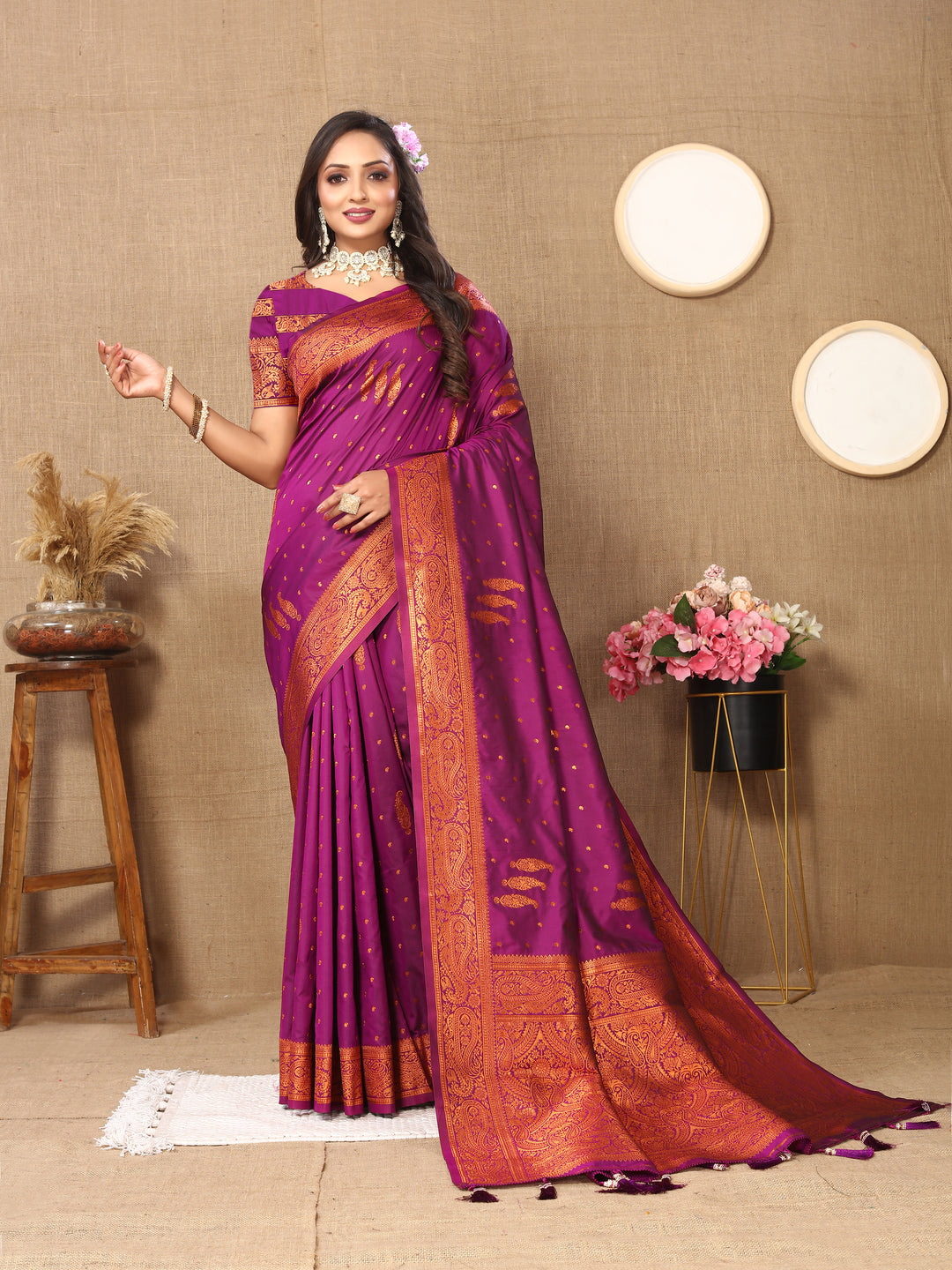 Rich purple paisley saree with intricate zari detailing and a contrast border, ideal for traditional functions.