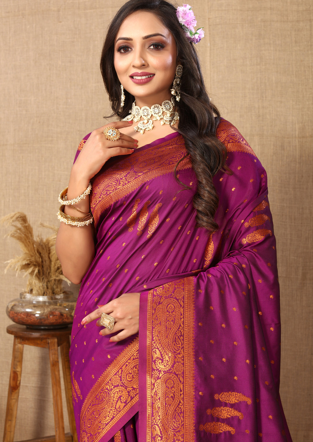 Stunning purple paisley woven saree with zari pallu and bold contrast border, perfect for grand celebrations.