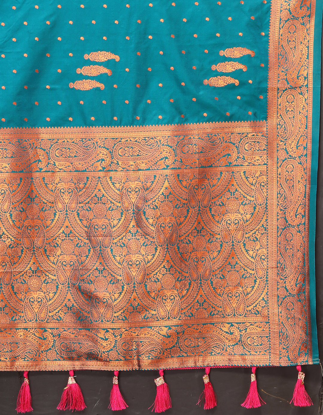 Elegant teal-blue paisley woven saree with intricate zari pallu and contrast border, designed for festive occasions.