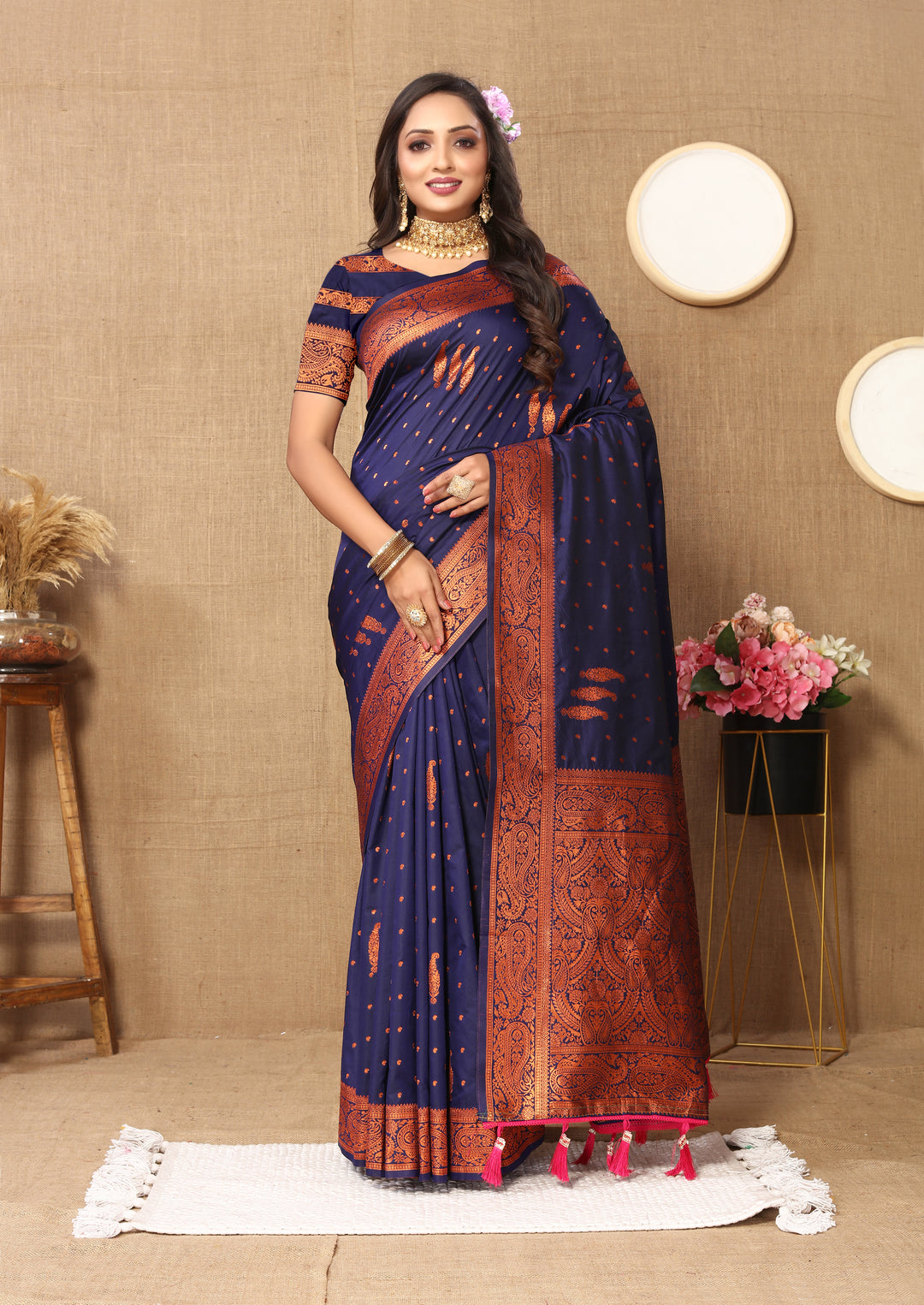 Timeless red paisley saree with zari pallu and bold contrast border, ideal for festive occasions.