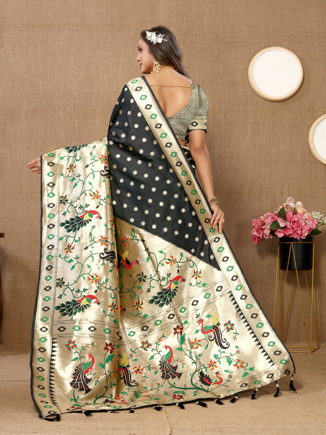 Timeless black silk saree with exquisite zari weaving, perfect for traditional gatherings.