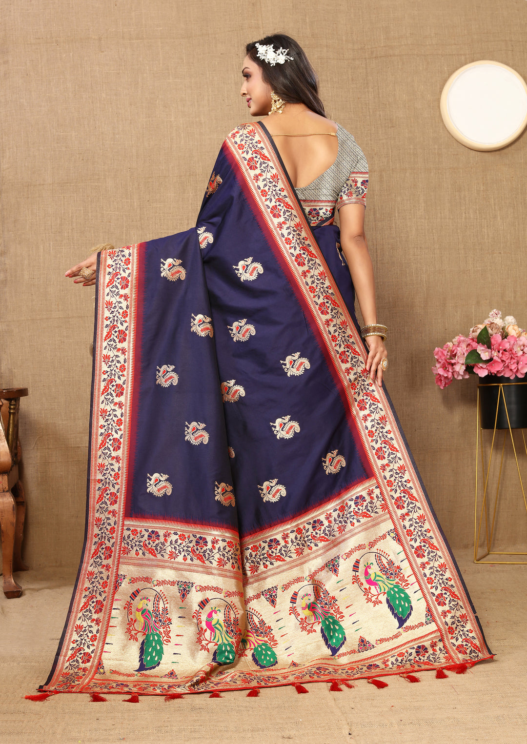 Navy Paithani silk saree with luxurious zari border and tassel details, ideal for festive occasions.