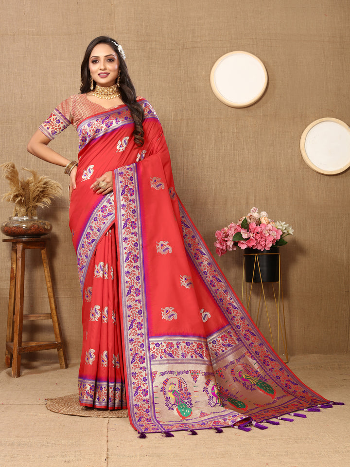 Elegant red silk saree featuring intricate zari border and tassels, ideal for weddings.