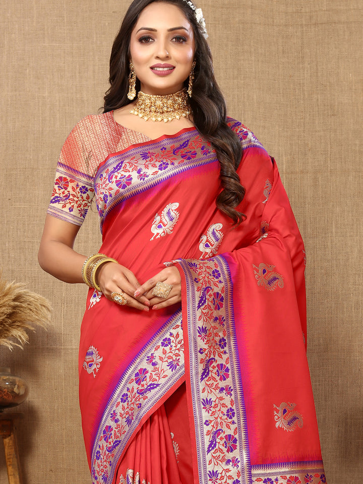 Designer red Paithani silk saree with luxurious zari work and tassels, perfect for grand occasions.