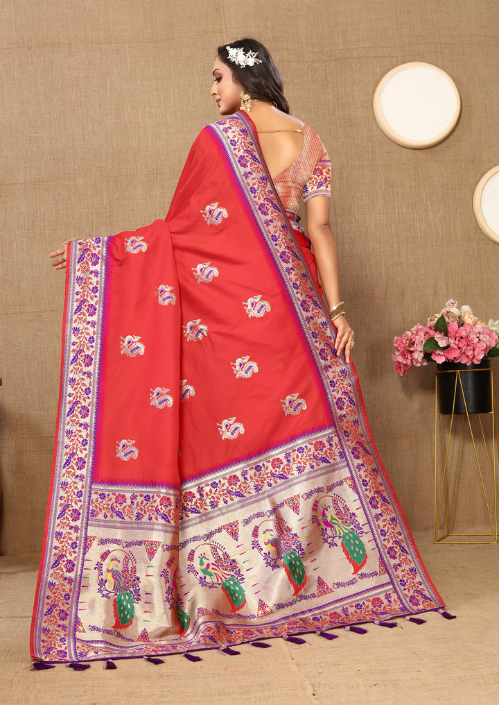 Timeless red silk saree with rich zari border and stylish tassels, ideal for traditional gatherings.