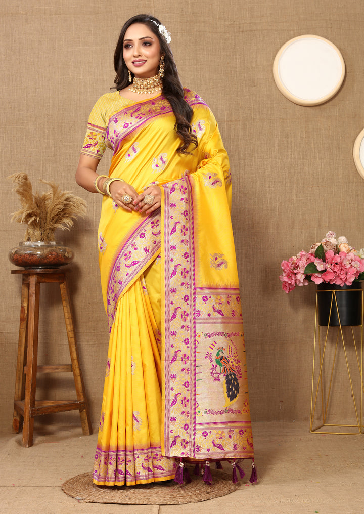 Elegant yellow silk saree with intricate zari border and tassels, perfect for weddings and ceremonies.