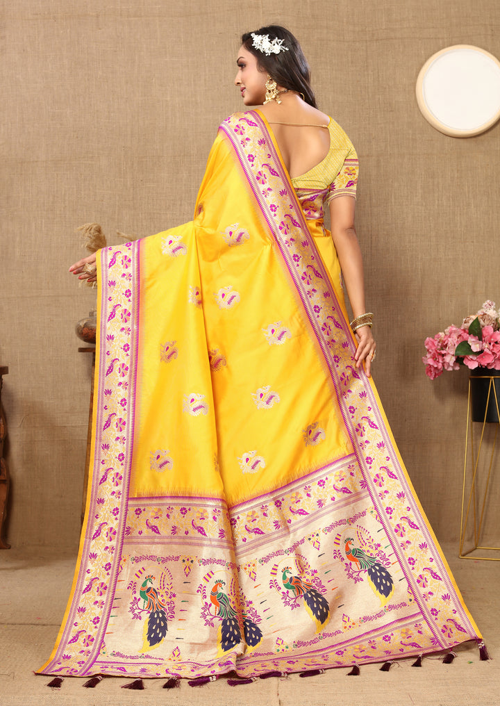 Yellow Paithani silk saree with beautiful zari border and stylish tassels, ideal for cultural events.