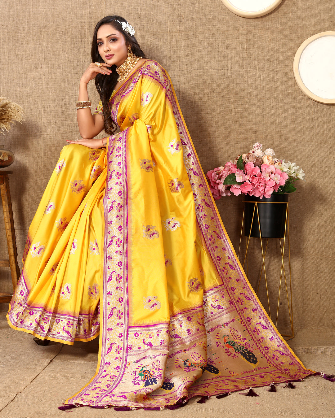 Timeless yellow silk saree with zari border and chic tassels, perfect for Indian celebrations.