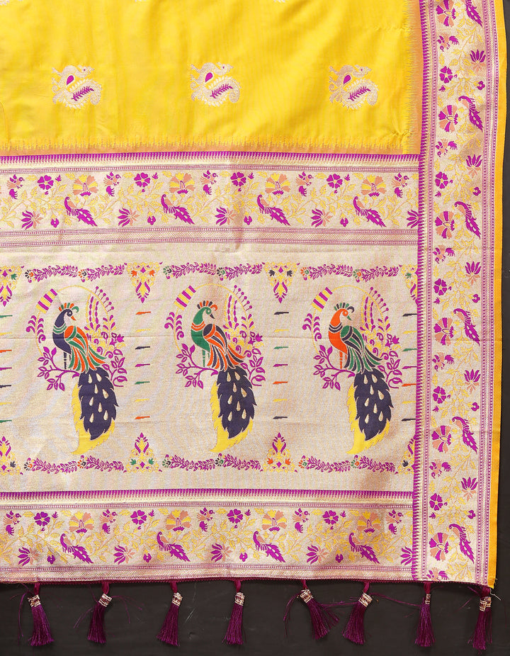 Yellow silk saree with zari border and chic tassels, ideal for traditional occasions.